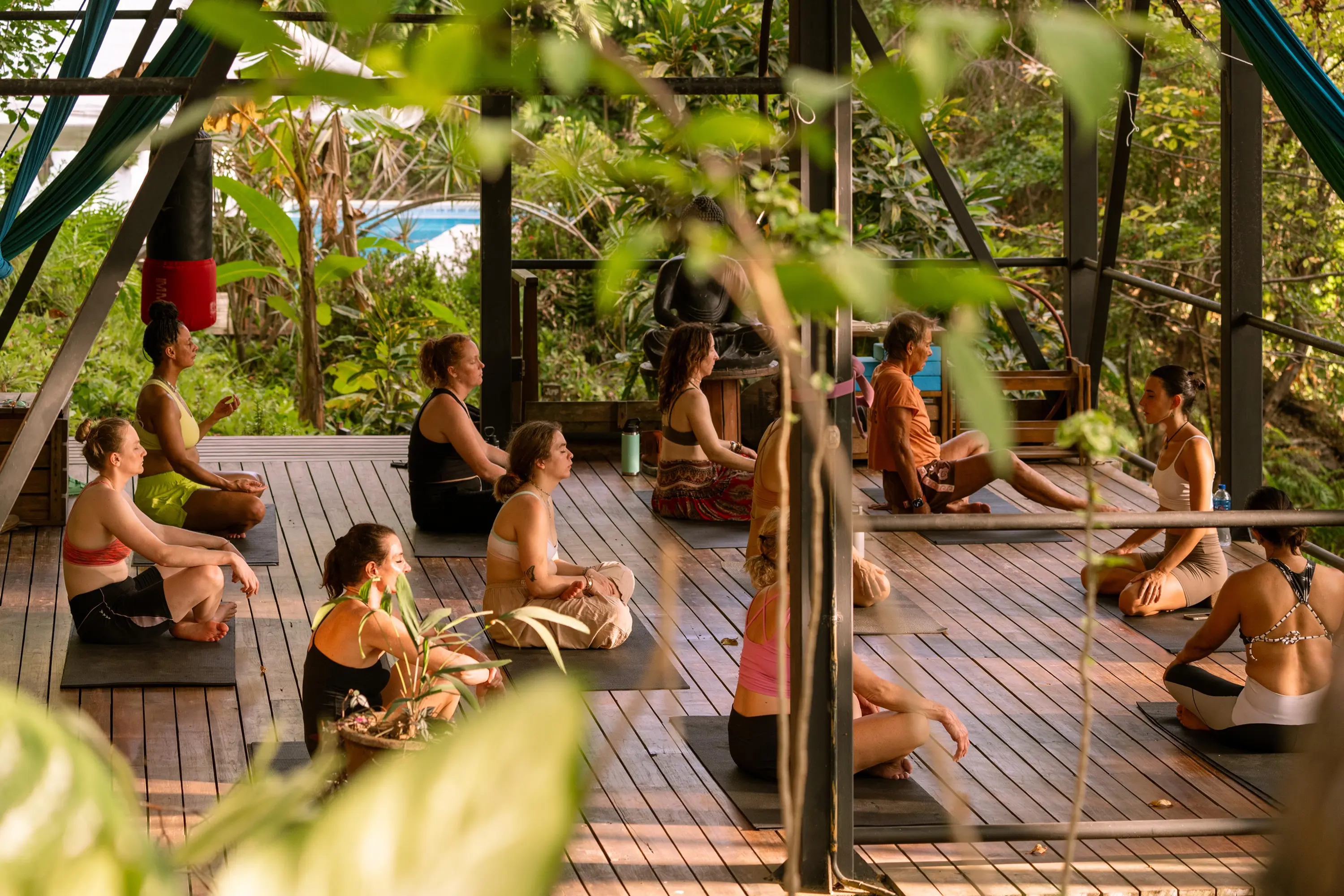 Yoga class on Funky Monkey Lodge's open-air wooden deck